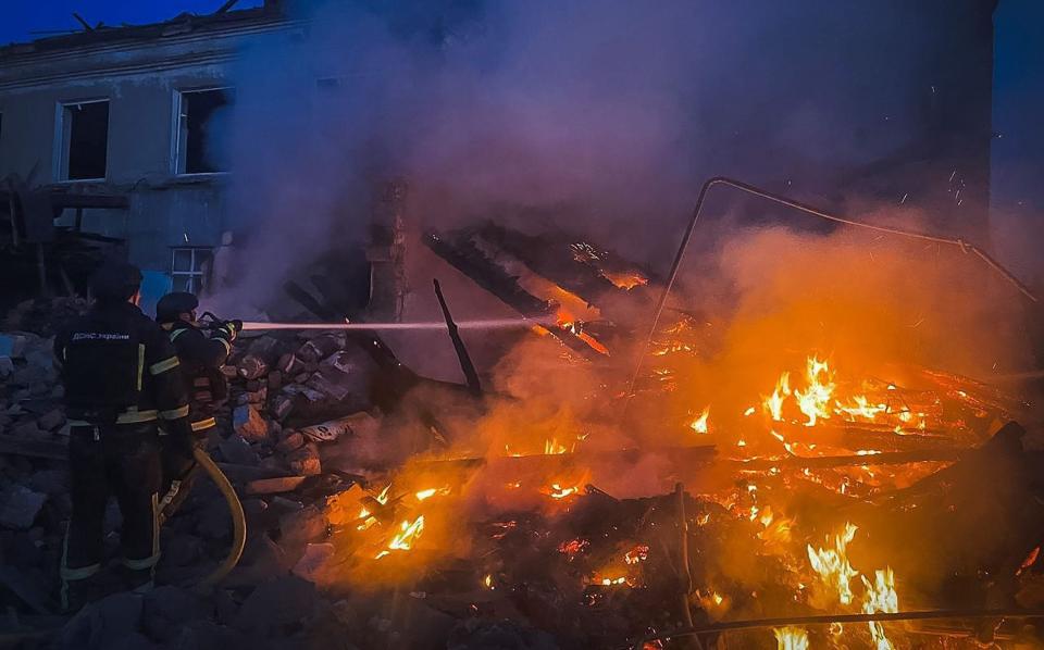 Rescue workers at the site of a shelling in Donetsk