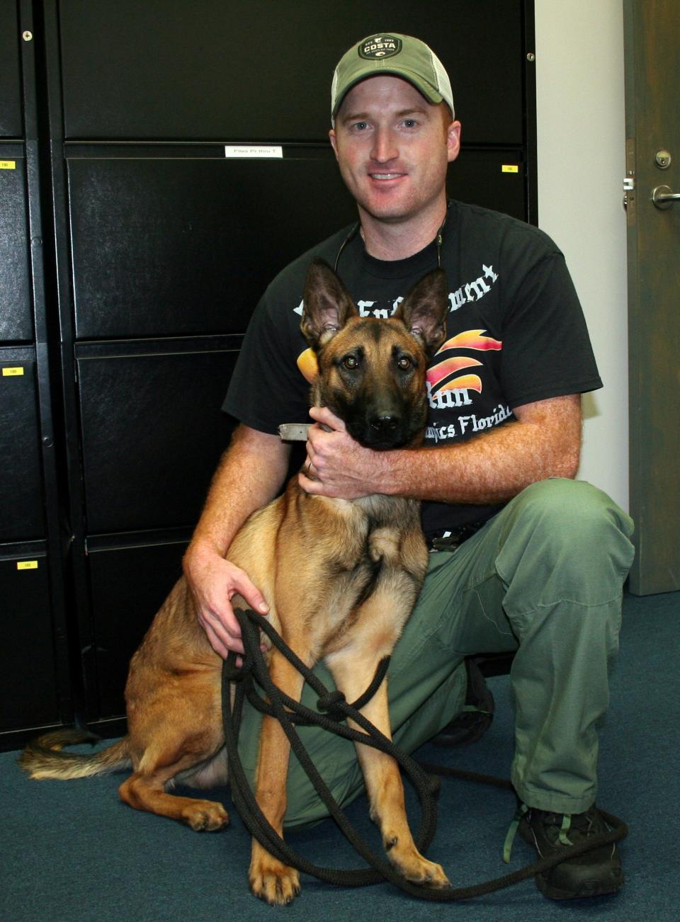 Former Lake Wales Police officer Jared Joyner is shown with his K9 partner, Max. The dog was killed by a suspect last August before Joyner and another officer fatally shot Earnest Borders.