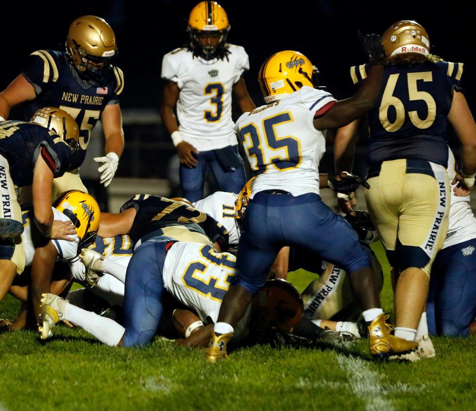 South Bend Riley senior Robert Nabieu (33) falls on the loose ball for a fumble recovery in the first half of a football game against New Prairie Friday, Sept. 29, 2023, at New Prairie High School in New Carlisle.