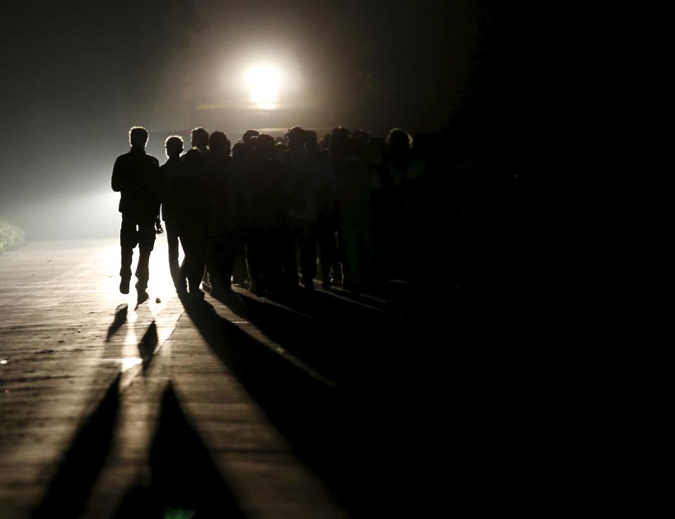 Family members of passengers of a sunken cruise ship march toward the site of the sunken ship in the Jianli section of Yangtze River, Hubei province