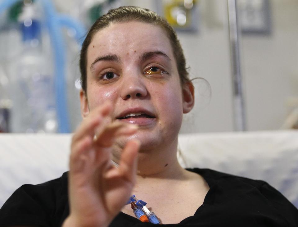 Washington mudslide survivor Amanda Skorjanc, 25, talks to the media while sitting in her hospital bed on Wednesday, April 9, 2014, in Seattle. On March 22, Skorjanic said she was trapped in a pocket formed by her broken couch and pieces of her roof. Skorjanic said that she remembers hearing the voices of several men coming to her aid, she had two broken legs and a broken arm. (AP Photo/The Herald, Dan Bates, Pool)