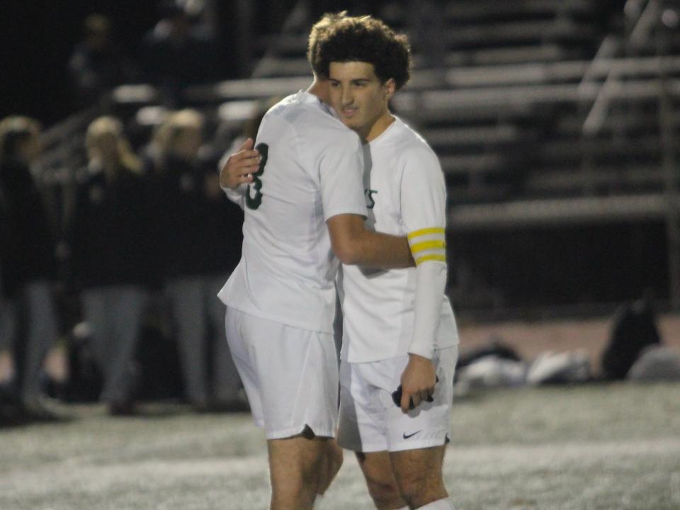 Dighton-Rehoboth senior captains Matt Suprenard (left) and Kristof Trond (right) embrace after falling to Norwell in the Division 3 Final Four.