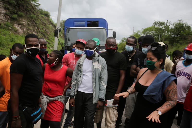 African, Cuban and Haitian migrants, which are stranded in Honduras after borders were closed due to the coronavirus disease (COVID-19) outbreak, rest while trekking northward in an attempt to reach the United States, in Choluteca