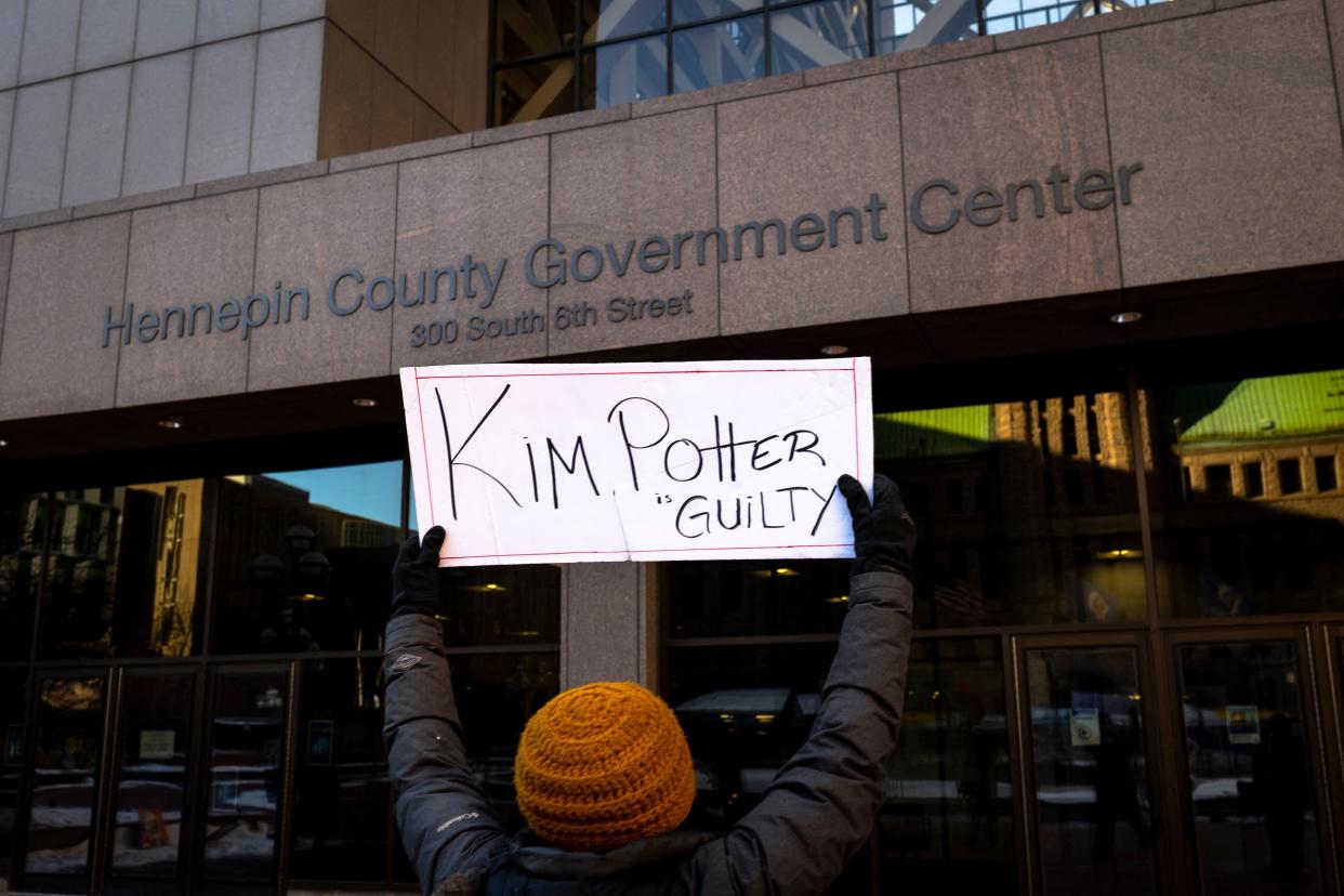 Marcia Howard, a local activist, holds a sign that reads "Kim Potter Guilty" outside the Hennepin County Government Center in Minneapolis, Minn. on Dec. 23, 2021, during jury deliberations in the trial of former police officer Kim Potter.