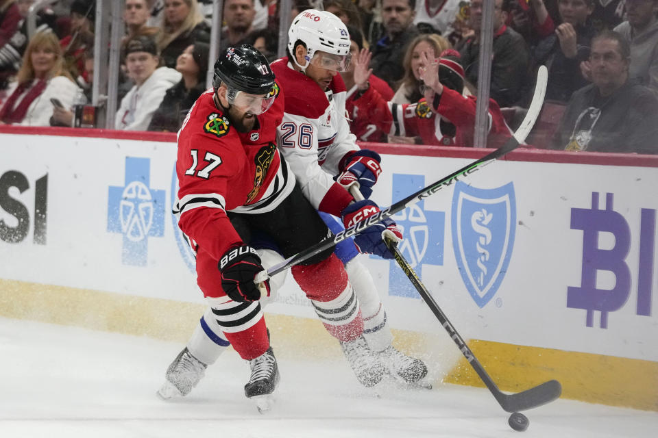 Chicago Blackhawks left wing Nick Foligno, left, and Montreal Canadiens defenseman Johnathan Kovacevic vie for control of the puck during the second period of an NHL hockey game Friday, Dec. 22, 2023, in Chicago. (AP Photo/Erin Hooley)