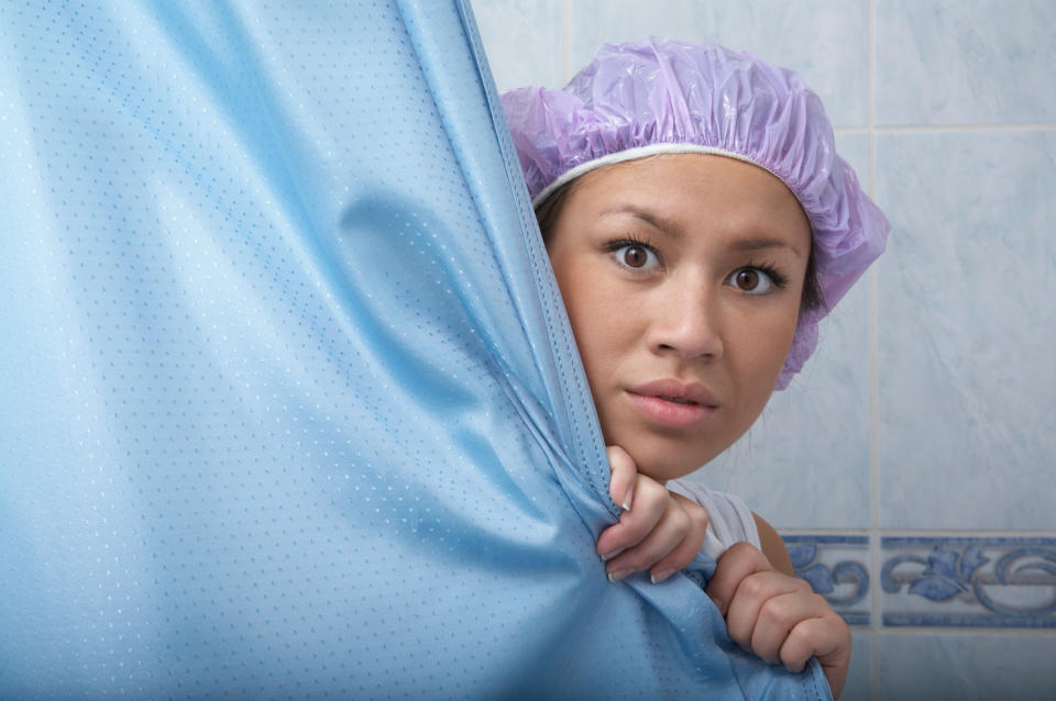 woman peeking out of the shower