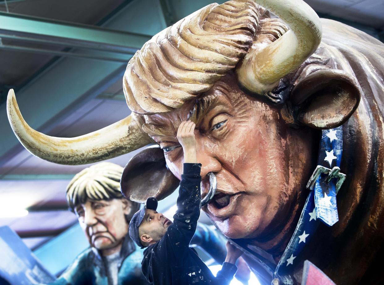 An artist works for media on a figure depicting US President Donald Trump as a bull during a press preview in a hall of the Mainz carnival club in Mainz, Germany,Tuesday, Feb. 26, 2019. Carnival groups and clubs in Germany are putting their final touches on their elaborate floats with outrageous caricatures depicting political themes for this yearâs parades during Carnival celebrations. (Photo: Michael Probst/AP)