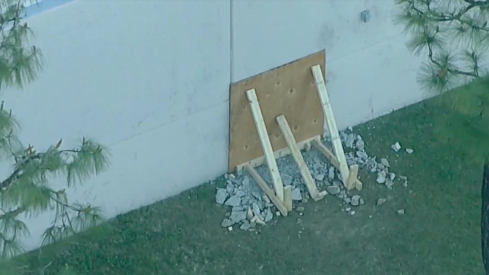 PHOTO: A boarded-up hole is seen in the wall of a building in Southern California where millions of dollars were stolen from a storage facility on Easter Sunday, March 31, 2024. (KABC)