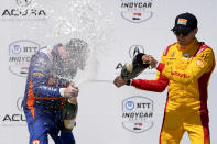 Chip Ganassi Racing driver Scott Dixon, left, is sprayed by Chip Ganassi Racing driver Álex Palou, right, after winning the IndyCar Grand Prix of Long Beach auto race Sunday, April 21, 2024, in Long Beach, Calif. (AP Photo/Ryan Sun)