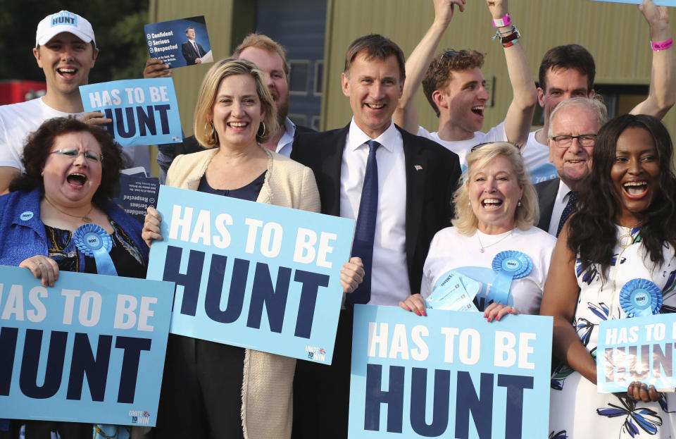 Britain's Conservative Party leadership candidate Jeremy Hunt, centre, with Secretary of State for Work and Pensions Amber Rudd, centre left, arrive for the Conservative Party leadership hustings meeting in Maidstone, southern England, Thursday July 11, 2019. The two contenders, Jeremy Hunt and Boris Johnson are competing for votes from party members, with the winner replacing Prime Minister Theresa May as party leader and Prime Minister of Britain's ruling Conservative Party. (Gareth Fuller/PA via AP)