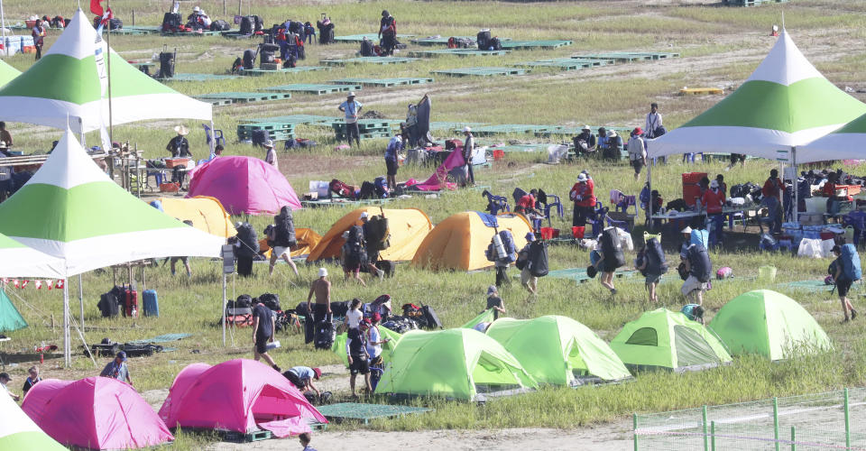 Attendees of the World Scout Jamboree prepare to leave a scout camping site in Buan, South Korea, Tuesday, Aug. 8, 2023. South Korea will evacuate tens of thousands of scouts by bus from a coastal jamboree site as Tropical Storm Khanun looms, officials said Monday. (Choe Young-soo/Yonhap via AP)