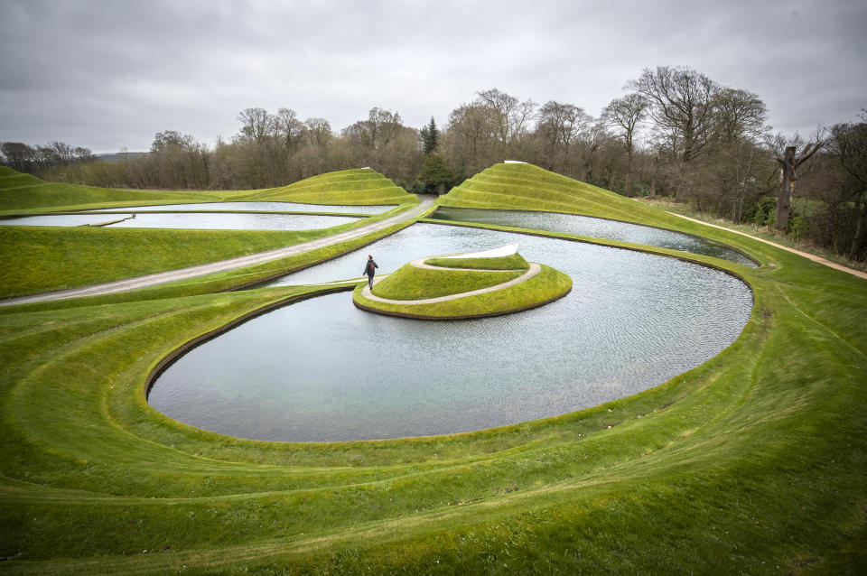 Grassy hills and water formed as an artwork