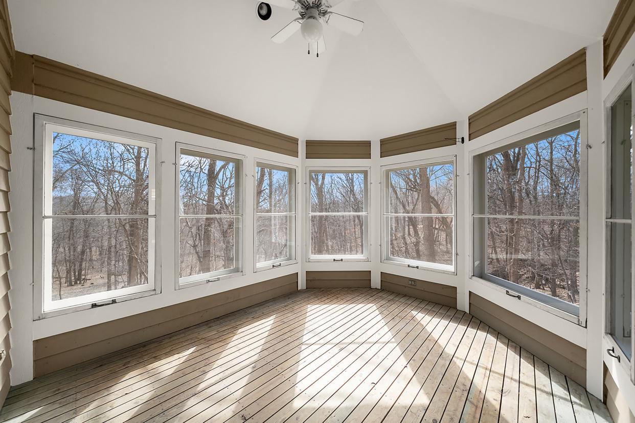 The screened-in porch overlooks the back yard.