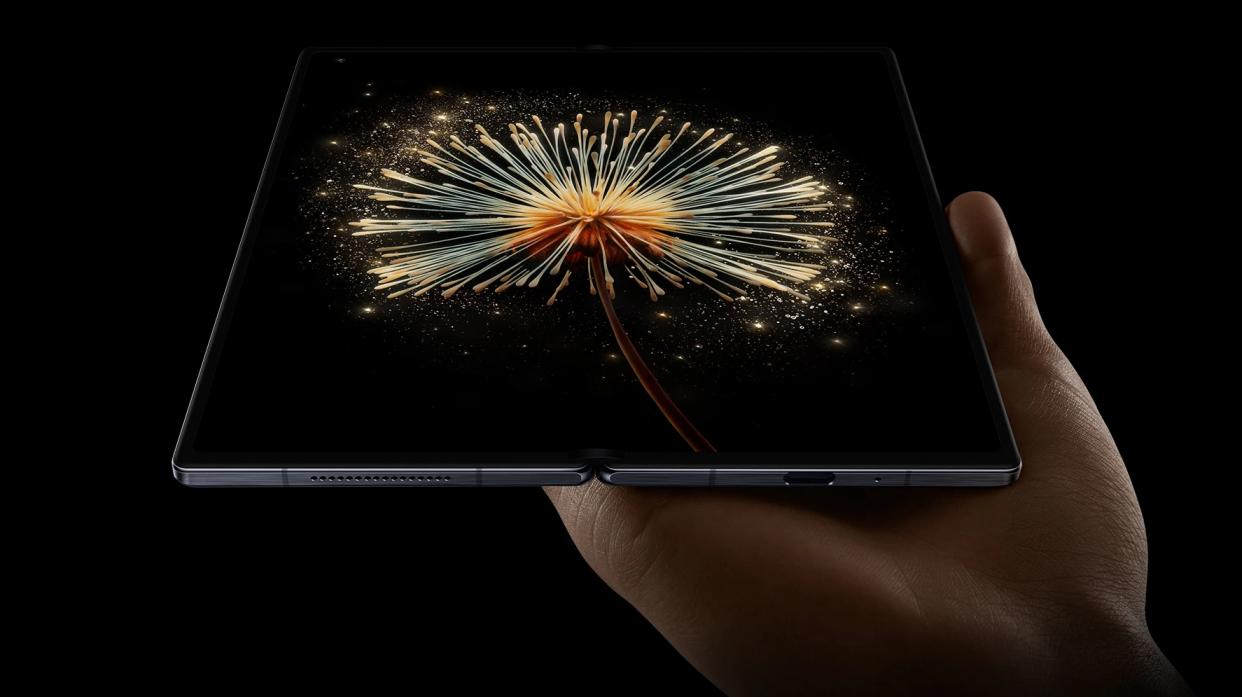  A marketing render of the Xiaomi Mix Fold 3 open in someone's hand 