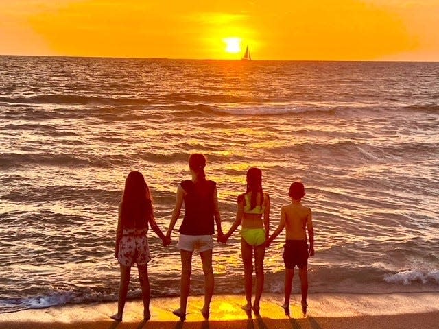 Members of the Savage family, from left to right - Isabella, Mary Kate, Reagan and Nicole Savage - watch a sunset during their Sanibel vacation in April.