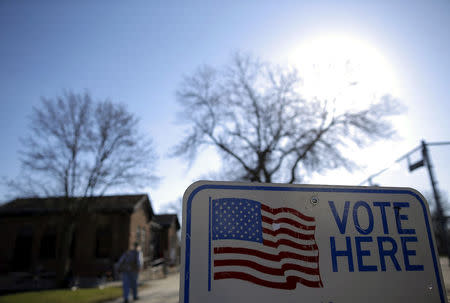 FILE PHOTO: A voter arrives to cast their ballot in the Wisconsin presidential primary election at a voting station in Milwaukee, Wisconsin, U.S. on April 5, 2016. REUTERS/Jim Young/File Photo