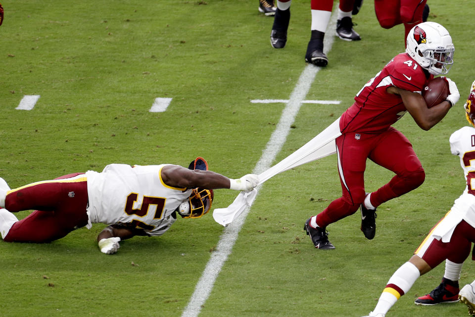 Arizona Cardinals running back Kenyan Drake (41) can't escape the grasp of Washington Football Team linebacker Kevin Pierre-Louis during the first half of an NFL football game, Sunday, Sept. 20, 2020, in Glendale, Ariz. (AP Photo/Darryl Webb)