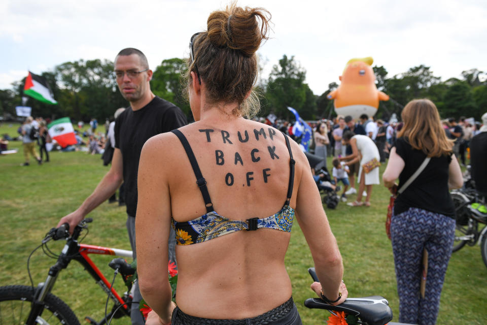 <p>The “Trump baby” balloon floats in the middle of crowds showing off anti-Trump signs in Edinburgh, Scotland, while the president is visiting Trump Turnberry Luxury Collection Resort in Scotland, July 14, 2018. (Photo: Jeff J. Mitchell/Getty Images) </p>