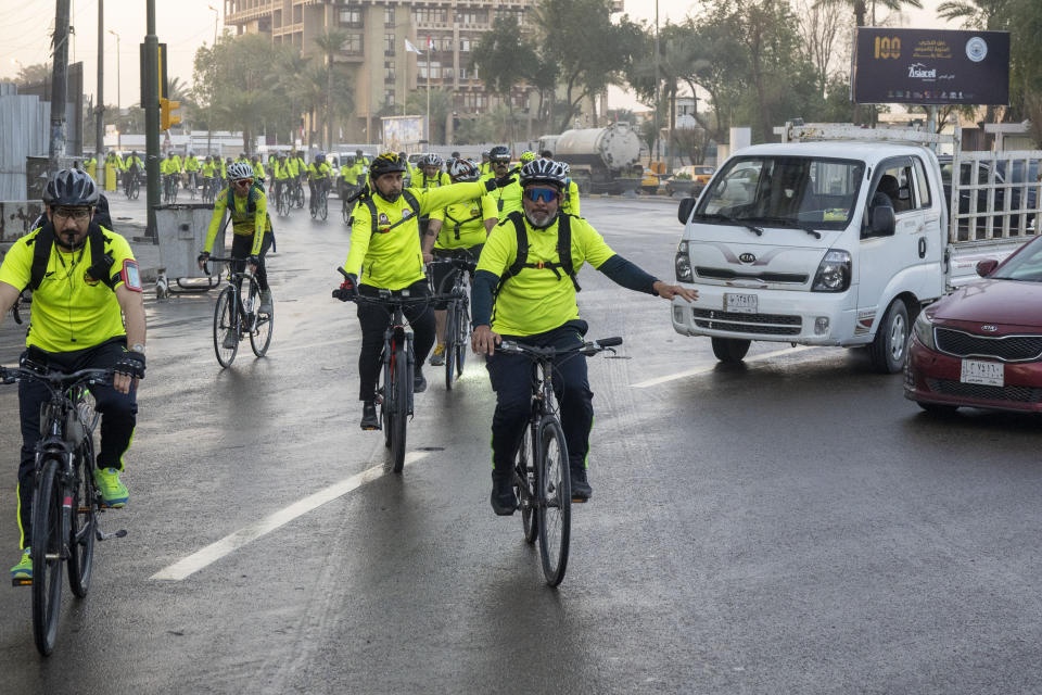Members of a cycling club take to the roads for a 50-kilometer (31-mile) trip in Baghdad, Iraq, on Tuesday, Feb. 28, 2023. The group organizes rides weekly for scores of men and women who see bike-riding as a healthy way to relieve life's stress and for good company. (AP Photo/Jerome Delay)