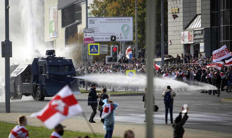 Police use a water cannon against demonstrators during a rally in Minsk, Belarus, Sunday, Oct. 4, 2020. Hundreds of thousands of Belarusians have been protesting daily since the Aug. 9 presidential election. (AP Photo)