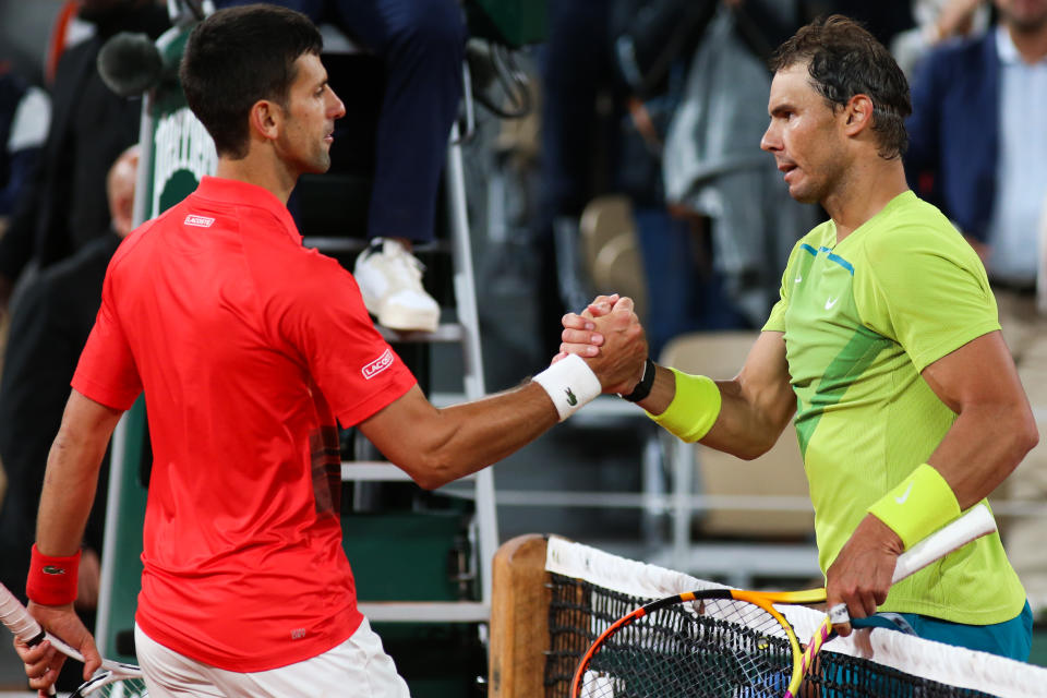 Novak Djokovic shakes hands with Rafa Nadal.