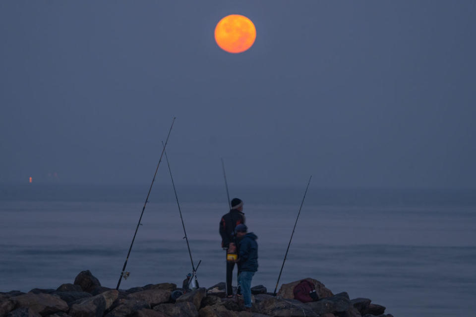 Fishermen catch a bite under the added illumination provided  by the Wolf Moon in Colombo, Sri Lanka, on January 25, 2024