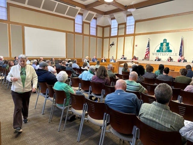 A large group of Westerville residents wore green shirts to show their opposition to the city's plans to install a foam densifier machine near their neighborhood. Before they had a chance to speak, Westerville City Council voted 7-0 to disband the project.
