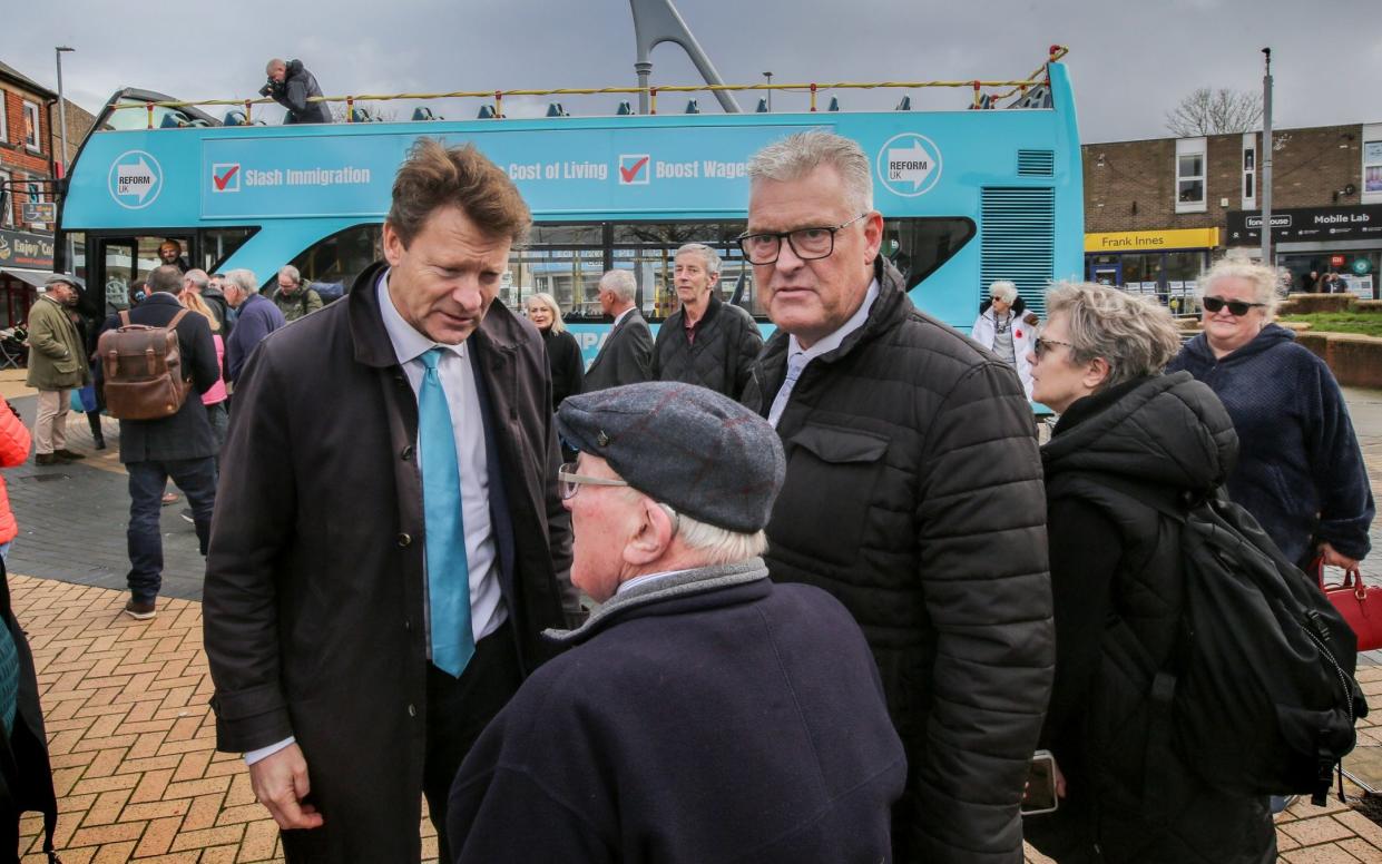 Richard Tice, left, and Lee Anderson speak to a supporter during a Reform UK campaign day