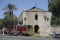 A firefighter stands outside the San Gabriel Mission in the aftermath of a fire, Saturday, July 11, 2020, in San Gabriel, Calif. The fire destroyed the rooftop and most of the interior of the nearly 250-year-old California church that was undergoing renovation. (AP Photo/Marcio Jose Sanchez)