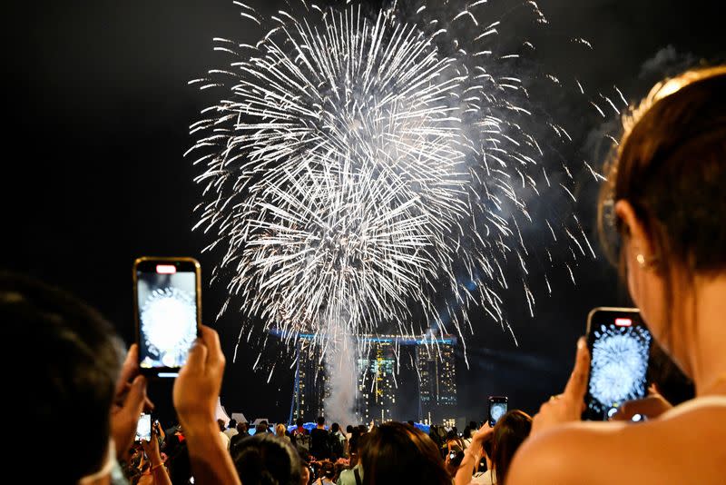 Fireworks are set off before midnight at the New Year countdown in Marina Bay