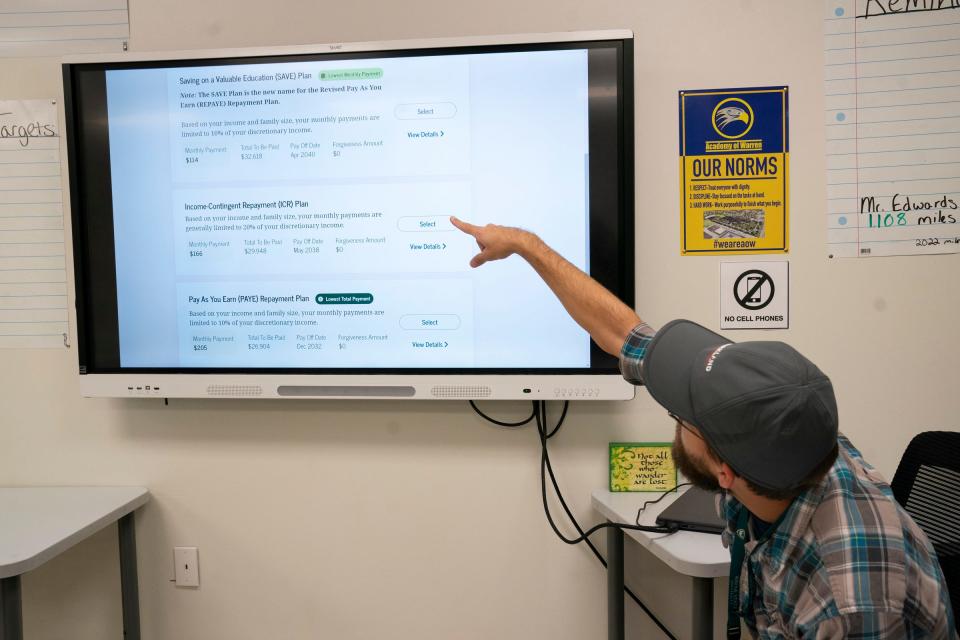 David Edwards, 31, of St. Clair Shores, and an English teacher at Academy of Warren looks up his student loan on Thursday, Aug. 31, 2023 from his classroom. Edwards is looking at paying $334.31 a month when his student loan payments resume.
