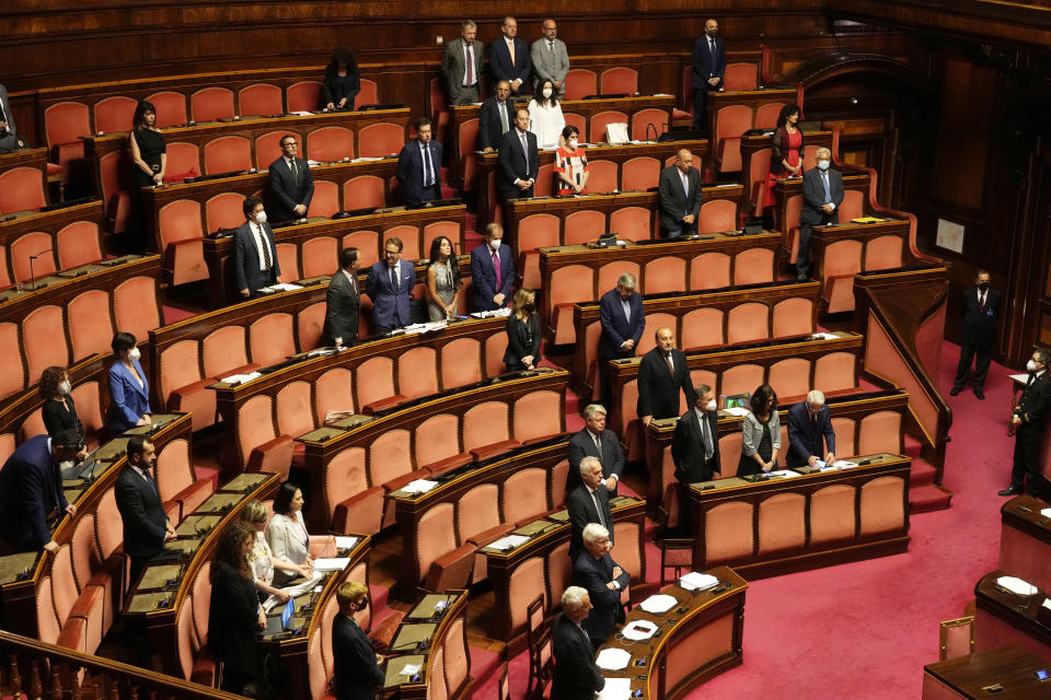 Senators observe a minute of silence in honor of late Italian journalist Eugenio Scalfari, at the Senate, in Rome, Thursday, July 14, 2022, before voting a bill on various economic measures. The stability of Italian Premier Mario Draghi's coalition government is at risk because 5-Star lawmakers say they will not participate in a confidence vote in Parliament. (AP Photo/Gregorio Borgia)