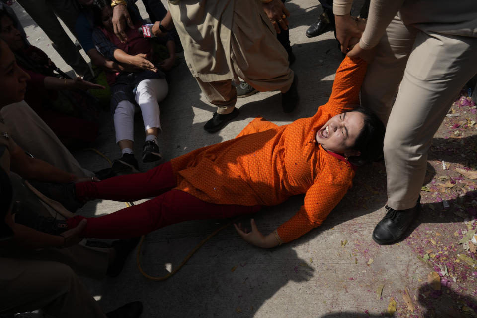 Policewomen detain a member of Aam Admi Party, or Common Man's Party, during a protest against the arrest of their party leader Arvind Kejriwal in New Delhi, India, Tuesday, March 26, 2024. Indian police have detained dozens of opposition protesters and prevented them from marching to Prime Minister Narendra Modi’s residence to demand the release of their leader and top elected official of New Delhi who was arrested last week in a liquor bribery case. (AP Photo/Manish Swarup)