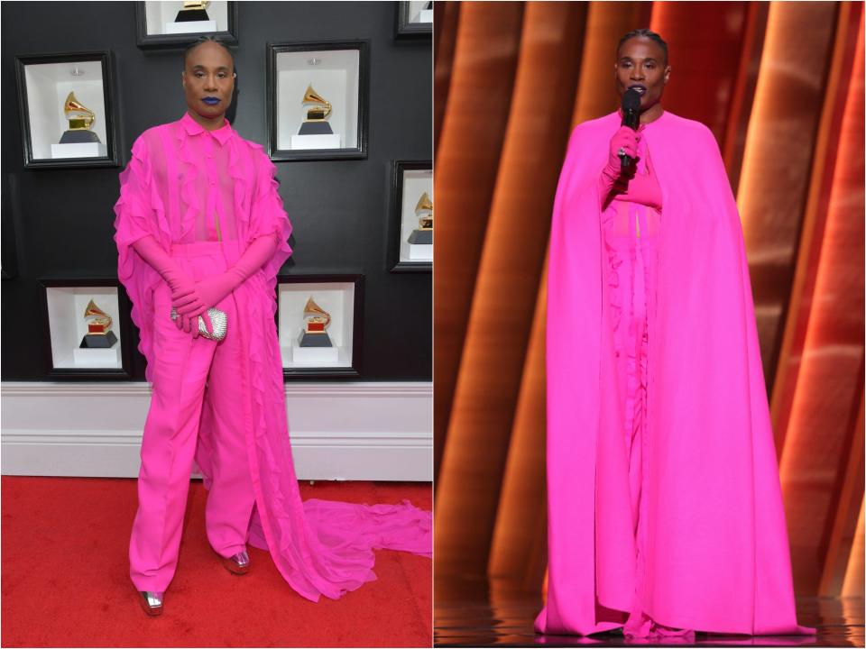 Billy in a neon pink sheer ruffled top with long cape sleeves and high-waisted pink trousers. He's wearing metallic platform boots. While presenting, he added a floor-length cape over the outfit.