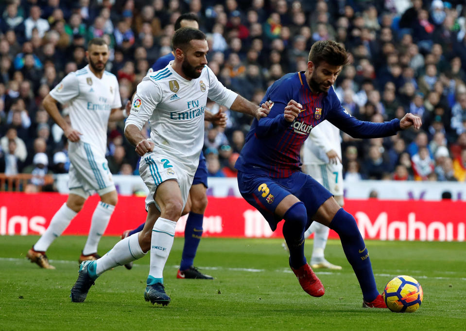 <p>Soccer Football – La Liga Santander – Real Madrid vs FC Barcelona – Santiago Bernabeu, Madrid, Spain – December 23, 2017 Barcelona’s Gerard Pique in action with Real Madrid’s Dani Carvajal REUTERS/Juan Medina </p>