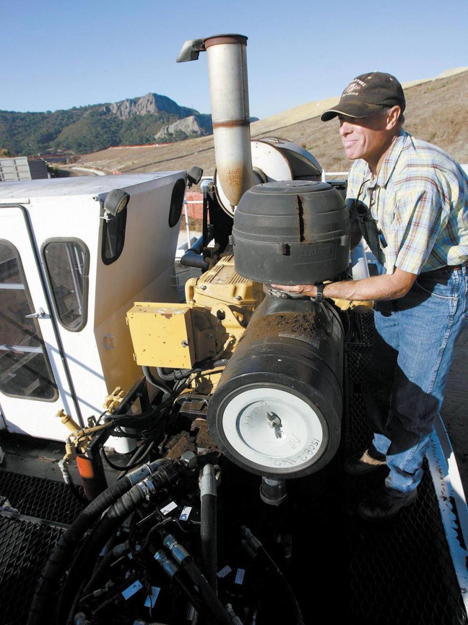 Bruce Rizzoli cleans out the air filter of the Scrab before starting it up at the Cold Canyon Landfill to turn over compost Nov. 16, 2006.