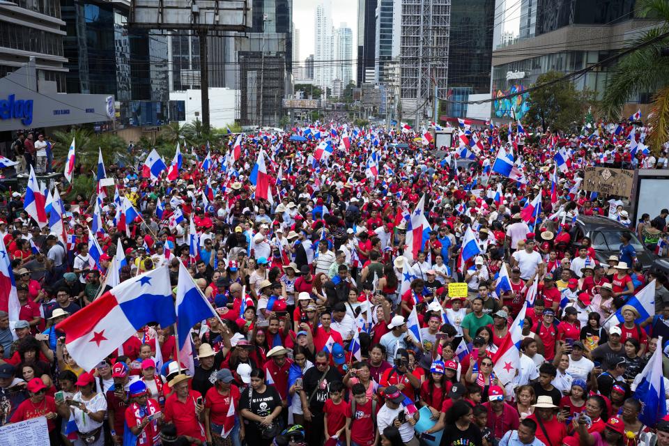 Panamanians celebrate after the Supreme Court declared a 20-year contract with a Canadian copper mine unconstitutional, in Panama City, Tuesday, Nov. 28, 2023. Panama's Supreme Court ruled unanimously that the concession that has been the focus of widespread environmental protests was unconstitutional, after which the president of the Central American country said the process to close the mine would begin. (AP Photo/Arnulfo Franco)