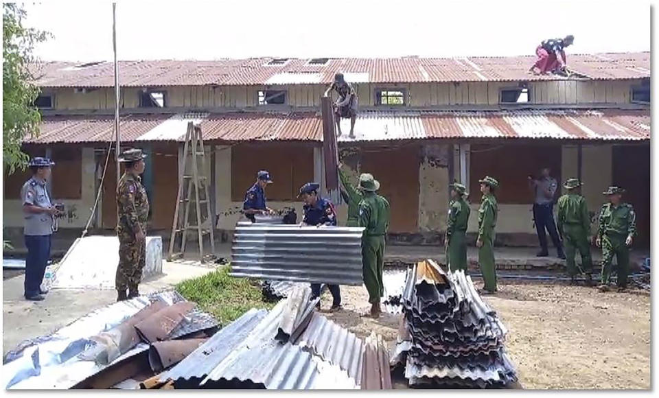 In this photo provided by Myanmar Military True News Information Team on Thursday, May 17, 2023, soldiers and members of fire service help to repair a damaged buildings after Cyclone Mocha in Pyapon township, Ayeyarwaddy Delta, Myanmar. At least 54 people were killed and more than 185,000 buildings damaged in Myanmar in last weekend's Cyclone Mocha, state television MRTV reported Thursday night. However, communication difficulties in the affected areas, whose existing infrastructure was already poor, and the military government's tight control over information leave the actual extent of casualties and destruction unclear. (Military True News Information Team via AP)