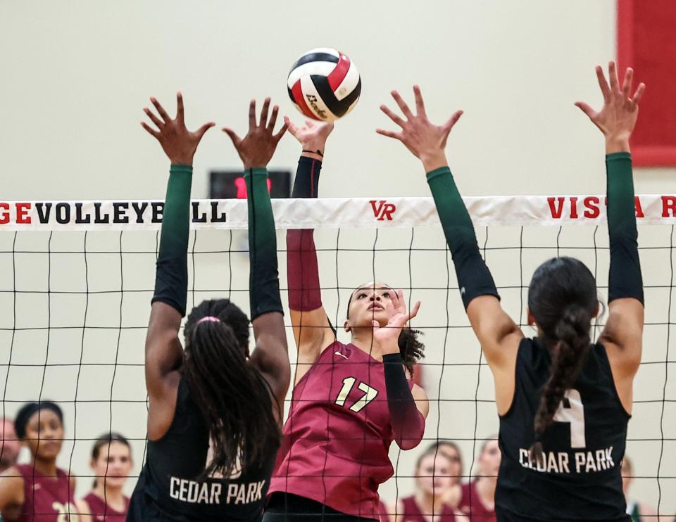 Rouse's Naara Tanco, center, hits a shot down the middle past Cedar Park defenders in the Raiders' 3-1 regional quarterfinal win at Vista Ridge High School. The win sent Rouse to the Region IV-5A tournament for the sixth time in the last eight years.
