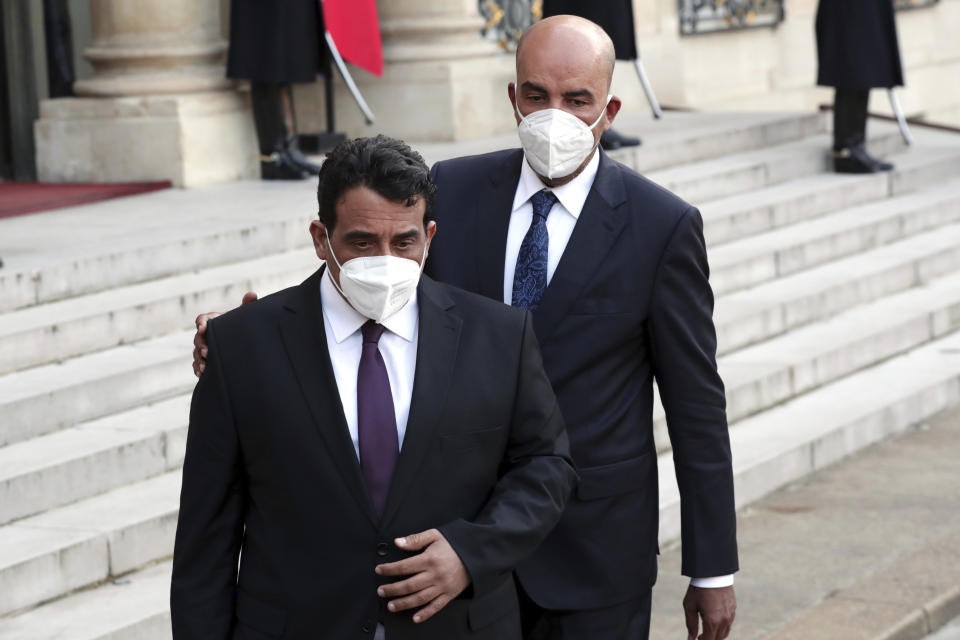 Mohammad Younes Menfi, president of Libya's Presidential Council, left, and Musa al-Koni, vice-president of Libya's Presidential Council arrive to deliver a speech at the end of a meeting, at the Elysee Palace, in Paris, Tuesday, March 23, 2021. Macron said France will reopen its embassy in Libya's capital Tripoli on Monday as a gesture of support for the new interim government. (AP Photo/Thibault Camus)