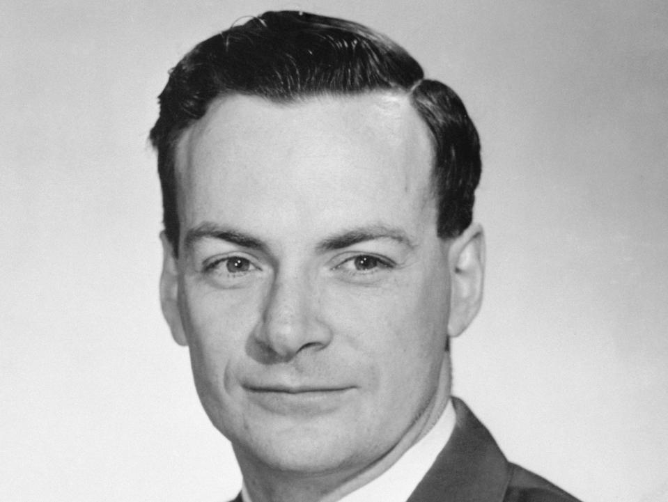 Nobel Prize winner Richard Feynman wears a suit against a light background in 1954