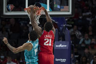 Philadelphia 76ers center Joel Embiid (21) dunks over Charlotte Hornets center Nick Richards (14) during the first half of an NBA basketball game, Wednesday, Dec. 8, 2021, in Charlotte, N.C. (AP Photo/Matt Kelley)