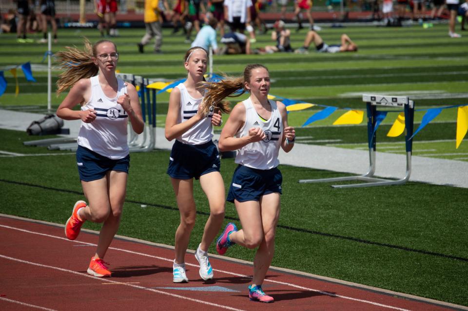 Hillsdale Academy runners Meredith Vanderweide, Whitney Wilkinson and Ella Walton compete in the 3200-meter run.