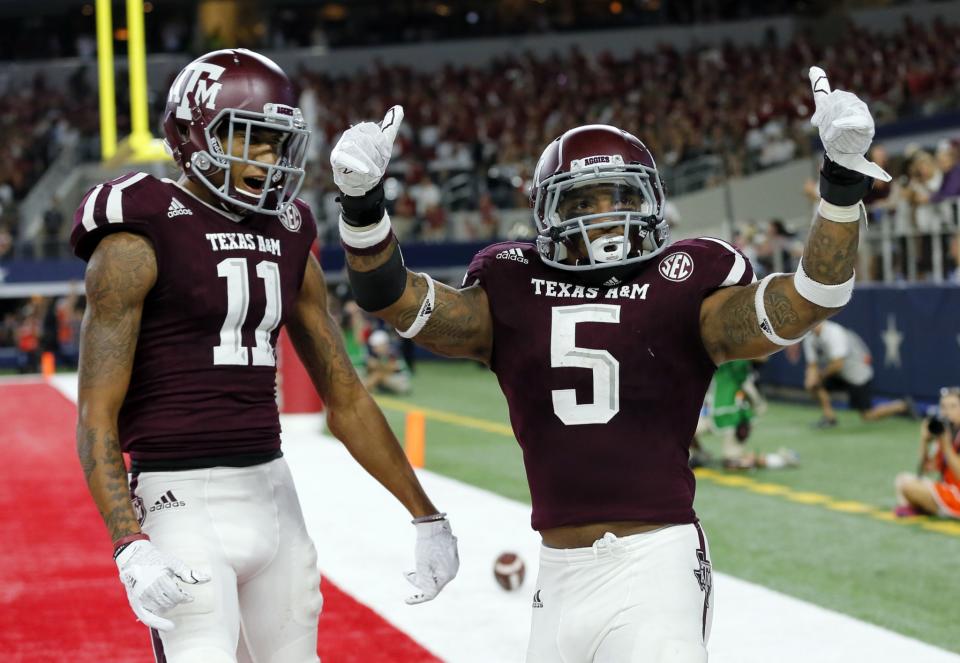 Josh Reynolds (left) and Trayveon Williams celebrate during Texas A&M's victory over Arkansas. (AP)