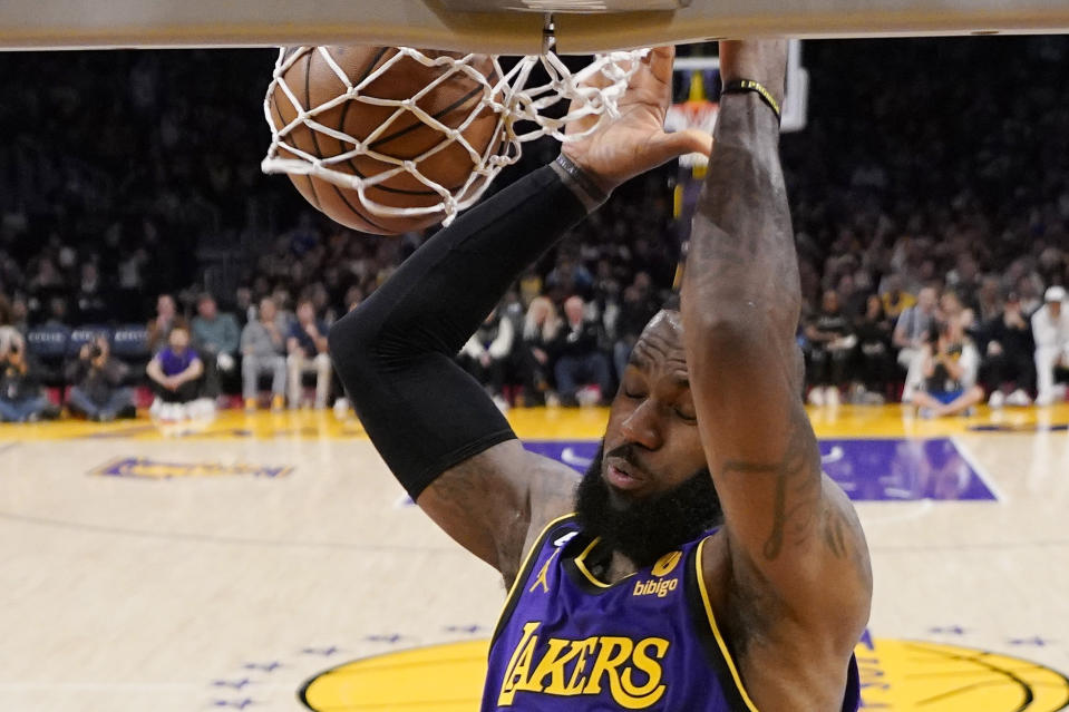 Los Angeles Lakers forward LeBron James dunks during the first half of an NBA basketball game against the Phoenix Suns Friday, April 7, 2023, in Los Angeles. (AP Photo/Mark J. Terrill)