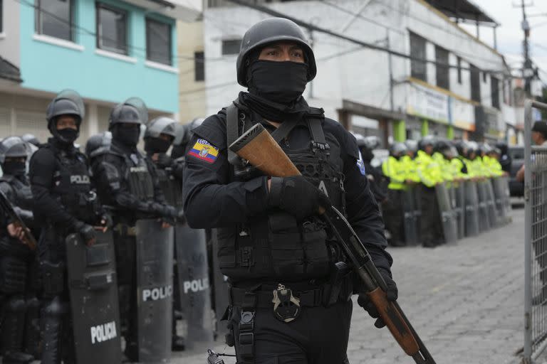 Policías y soldados se encuentran afuera de la prisión El Inca después de que comenzaron los disturbios en el interior en Quito, Ecuador, el lunes 8 de enero de 2024. (Foto AP/Dolores Ochoa)