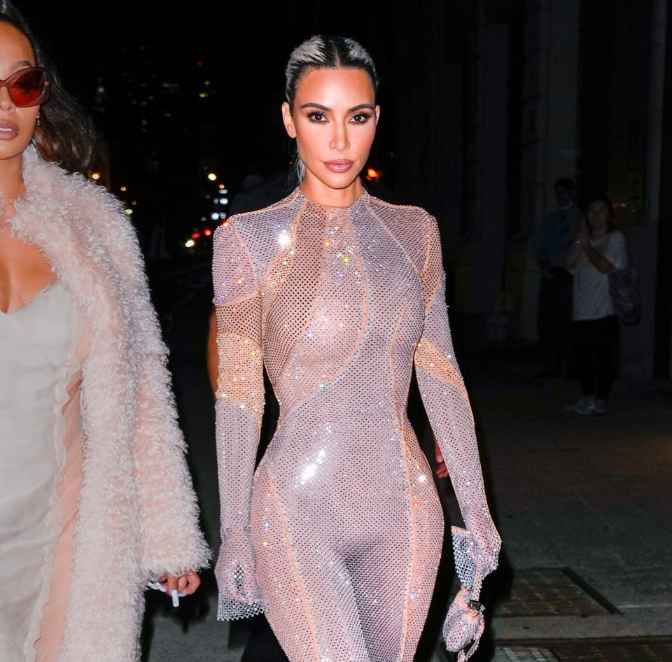 Kim in a shiny, bodycon bodysuit