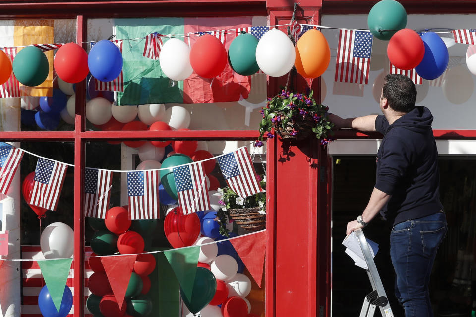 Last minute preparation are made with bunting and US flags put up in the town of Ballina ahead of the visit by President Joe Biden to St Muredach's Cathedral, in Ballina, Ireland, Friday, April 14, 2023. The President will give a speech later Friday outside the cathedral. (AP Photo/Peter Morrison)