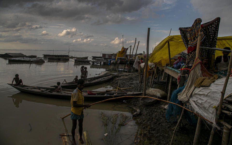 Indian flood affected people take shelter at temporary structures near their submerged house along river Brahmaputra in Morigaon district, Assam, India, Thursday, July 16, 2020. Floods and landslides triggered by heavy monsoon rains have killed dozens of people in this northeastern region. (AP Photo/Anupam Nath)