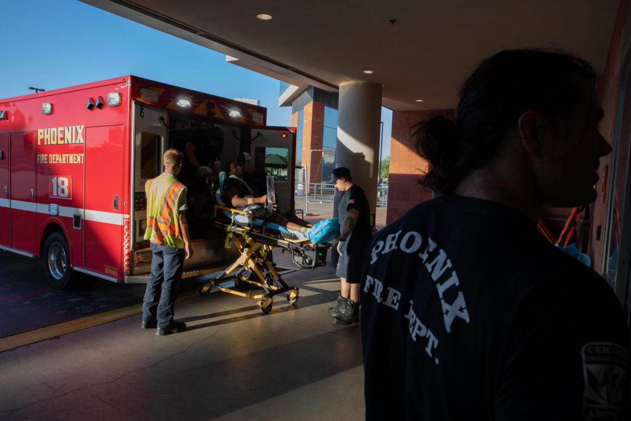 <span>Paramedics in Phoenix, Arizona, rush a resident to the hospital during a heatwave on 20 July 2023.</span><span>Photograph: Bloomberg/Getty Images</span>